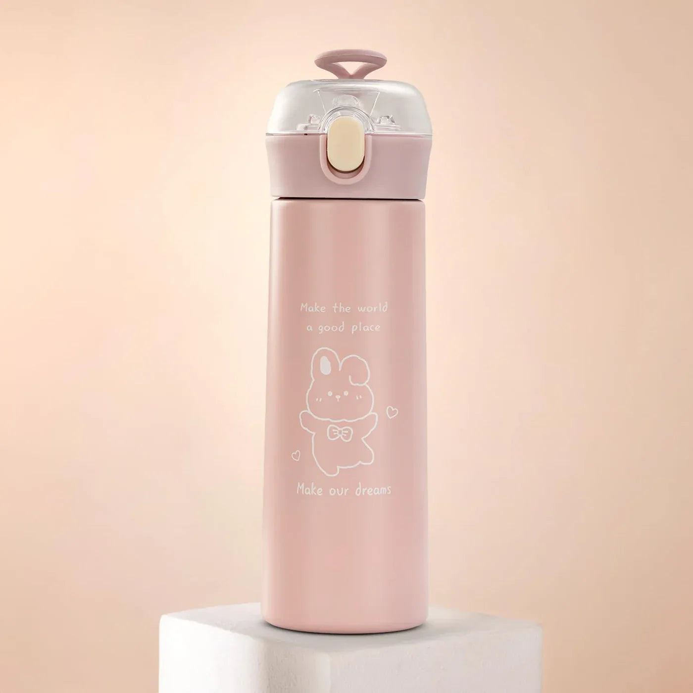 Pink water bottle with a cartoon design on a light pink background