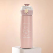 Pink water bottle with a cartoon design on a light pink background