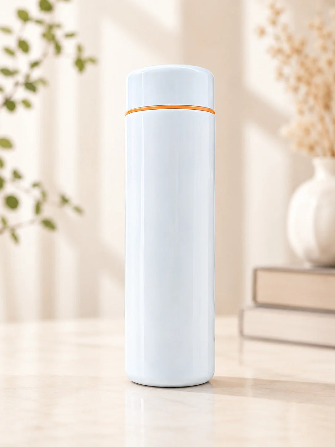 White thermos bottle with orange rim on a light wooden surface with a blurred background