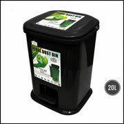 Black pedal dust bin with green labels on a white background