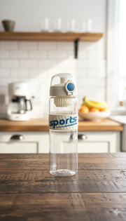 Clear water bottle with 'sports' label on a wooden table in a kitchen.