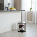 Stainless steel trash can with a label in a kitchen setting