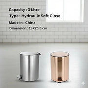 Two trash bins, one silver and one rose gold, on a light gray surface with a tiled wall background.