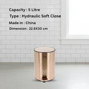 Rose gold trash bin with product details on a white tiled wall background