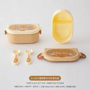 Children's lunch box set with compartments and accessories on a white background